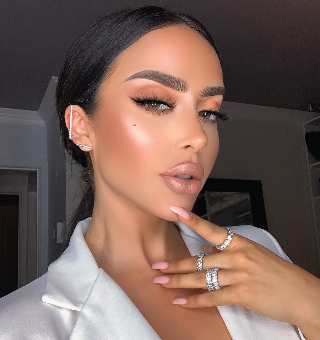 Model wearing gold and silver rings and jewelry.